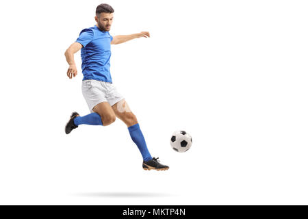 Full length portrait of a soccer player in mid-air kicking a football isolated on white background Stock Photo