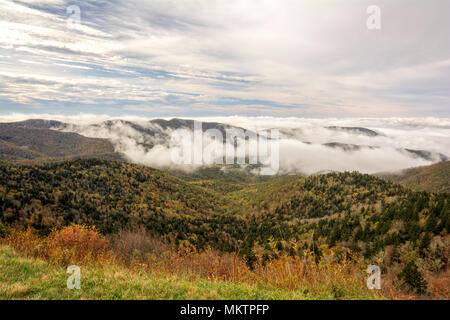 Early morning fog settles into the valleys of the mountains along the Blue Ridge Parkway in Western North Carolina on a crisp autumn October day.