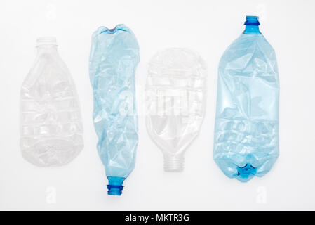 Empty crushed plastic bottles on light background. Stock Photo