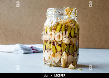 Honey Flavored Nuts, Almonds and Peanut Brittle Dessert in Jar. Organic Food. Stock Photo
