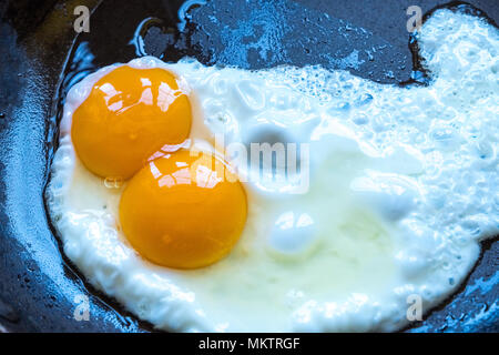 A double yoke egg frying in a pan Stock Photo