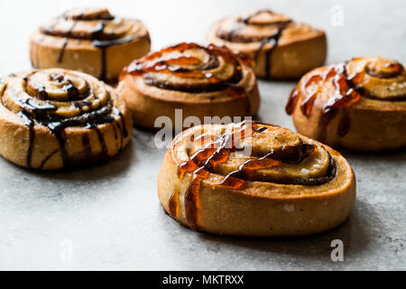 Freshly Baked Cinnamon Rolls with Caramel and Chocolate Sauce. Ready to Eat. Stock Photo
