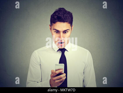 Shocked business man checking his phone Stock Photo