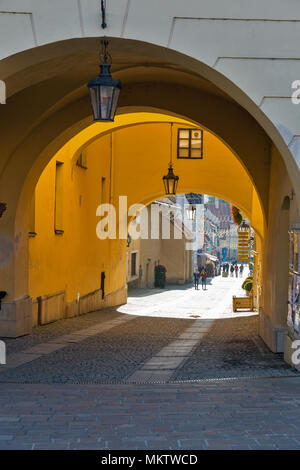 PRESOV, SLOVAKIA - OCTOBER 01, 2017: People walk along ancient gate on Hlavna Square in Old Town. It is a city in Eastern Slovakia, the third largest  Stock Photo