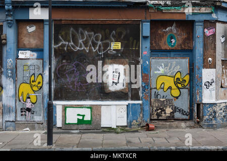 Boarded up building covered in graffiti and  Street Art, Paul Street, London, EC2 Stock Photo