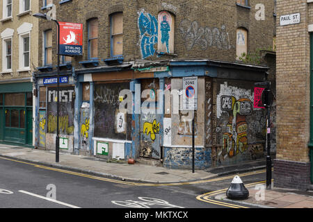 Boarded up building covered in graffiti and  Street Art, Paul Street, London, EC2 Stock Photo