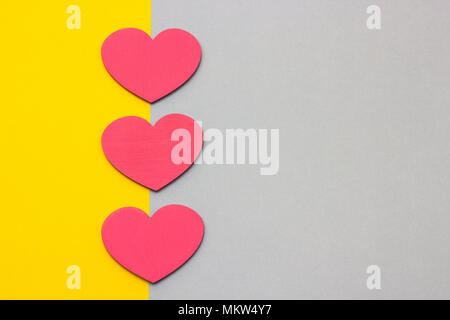 Wooden hearts on a multi-colored background, top view Stock Photo