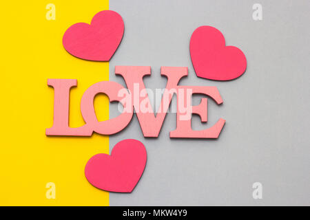 Wooden hearts on a multi-colored background, top view Stock Photo