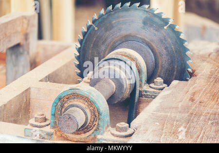 Carpenter cutting flaxboard using sliding compound mitre saw Stock Photo