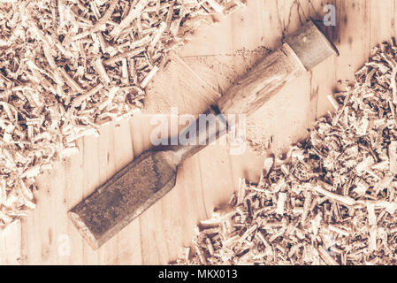 Carpenter tools on wooden table with sawdust. Carpenter workplace top view Stock Photo
