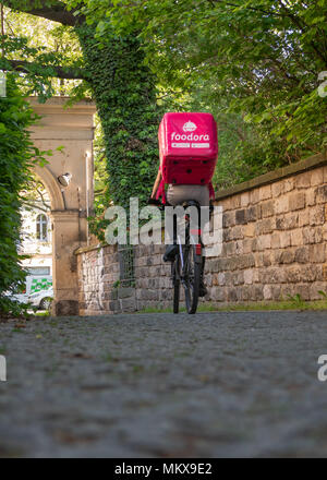 Dresden, Germany: Food delivery service. A female foodora courier on her way to the next restaurant. Stock Photo