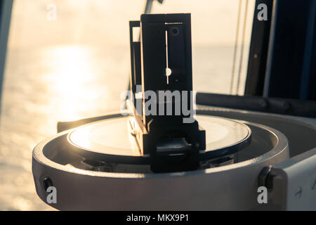Close up of nautical marine magnetic compass on yacht or boat Stock Photo