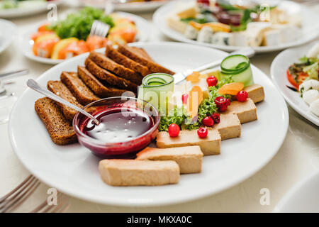 Beautifully decorated catering banquet table with different food snacks and appetizers on corporate christmas birthday party event or wedding celebration Stock Photo