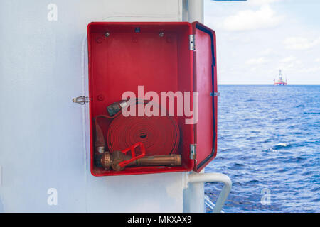 Fire prevention onboard vessel at sea. Fire cabinet with fire equipment Stock Photo