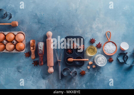 https://l450v.alamy.com/450v/mkxbye/making-pastry-flat-lay-with-wooden-scoops-whisks-cookie-cutters-muffin-tin-sugar-flour-eggs-and-cinnamon-on-a-modern-concrete-background-with-copy-space-baking-tools-and-ingredients-from-above-mkxbye.jpg