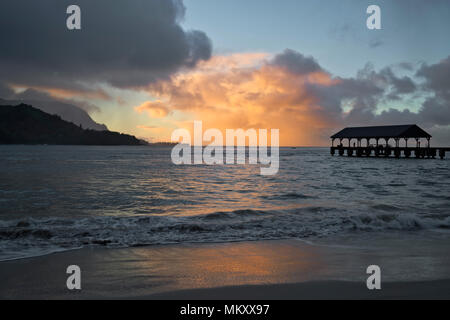 Storm clouds part at sunrise over the magical Hanalei Bay on Hawaii’s Island of Kauai. Stock Photo