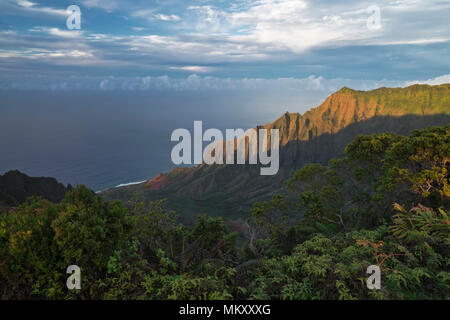 Evening light bathes the mystical Kalalau Valley and Na Pali Coast on Hawaii’s Island of Kauai. Stock Photo