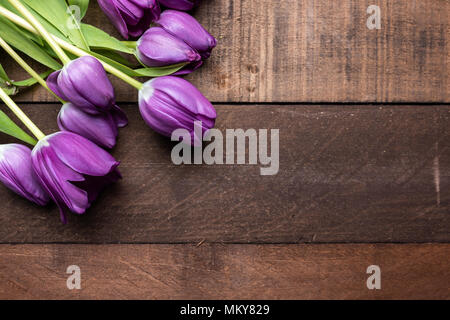 Purple tulips on wooden background Stock Photo