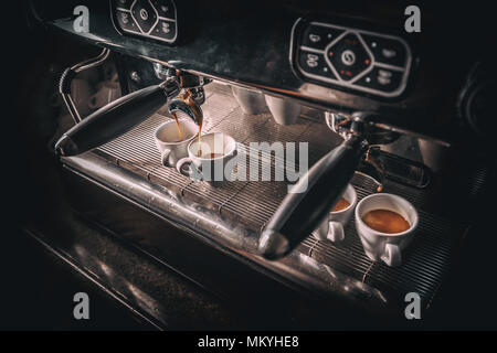 Espresso pouring from coffee machine. Professional coffee brewing Stock Photo