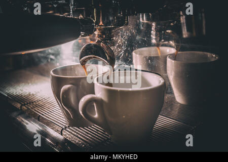 Coffee making in the coffee machine close-up, toned image Stock Photo