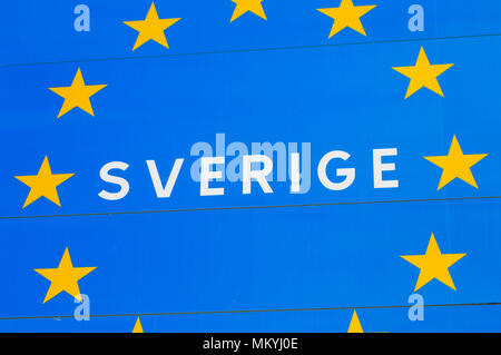 Close up of a road sign at the border to a EU member state Sweden, with the Swedish Sverige for Sweden incircled by golden stars on blue background. Stock Photo