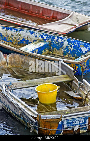 A collection of small and neglected rowing boats, all of which have seen better days! Stock Photo