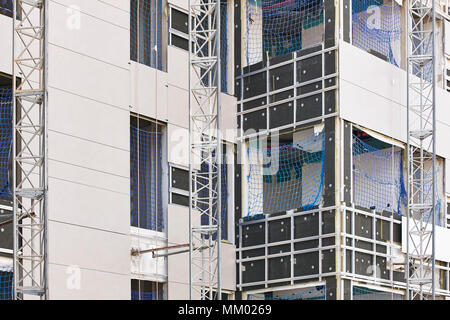 Building facade under construction. Insulation material and tiles ...