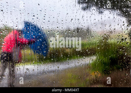 Ardara, County Donegal, Ireland  weather. 9th May 2016. A person struggles to work on a rainy, windy start to the day on Ireland's west coast. Seen through the window of a cottage. Credit: Richard Wayman/Ģ����ý Live News Stock Photo