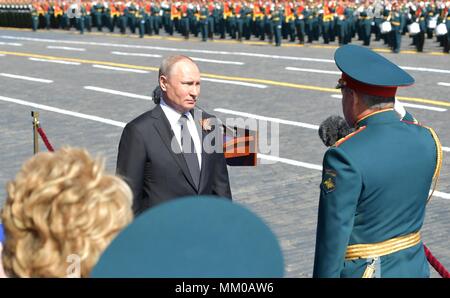 Russian President Vladimir Putin is saluted by Kremlin Guards as he ...