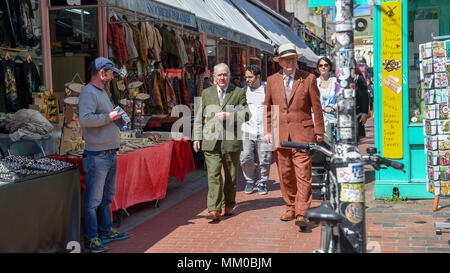 Brighton UK 9th May 2018 - Renowned artists Gilbert (left). and George walking around the North Laine area of Brighton before visiting their own exhibition at Brighton Museum and Art Gallery which is showing until September until September .  Photograph taken by Simon Dack Stock Photo