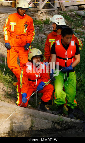 (180509) -- CHENGDU, May 9, 2018 (Xinhua) -- File photo taken on May 7, 2009 shows Jiang Yuhang (L, front) taking part in a rescue mission in Miaohang Township of Shanghai Municipality, east China. On May 17, 2008, Jiang, a 20-year-old highway administration employee, was extricated by firefighters, 123 hours after he was trapped in the rubble at quake-hit Yingxiu Township of Wenchuan County, southwest China's Sichuan Province. Jiang was a survivor of the 8.0-magnitude earthquake that struck Sichuan's Wenchuan County on May 12, 2008. The quake left more than 69,000 dead, 374,000 injured, 18 Stock Photo