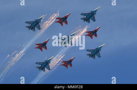 Russian Knights aerobatic demonstration team fly Sukhoi Su-30SM fighter aircraft alongside Mikoyan MiG-29 fighters flown by the Swifts perform a flyby pass over the review stand during the military parade on the 73rd Victory Day marking the end of World War II in Red Square May 9, 2018 in Moscow, Russia.  (Russian Presidency via Planetpix) Stock Photo