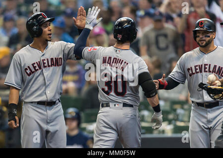 Milwaukee, WI, USA. 9th May, 2018. Cleveland Indians center fielder Tyler  Naquin #30 is congratulated by Cleveland Indians left fielder Michael  Brantley #23 and Cleveland Indians first baseman Yonder Alonso #17 after