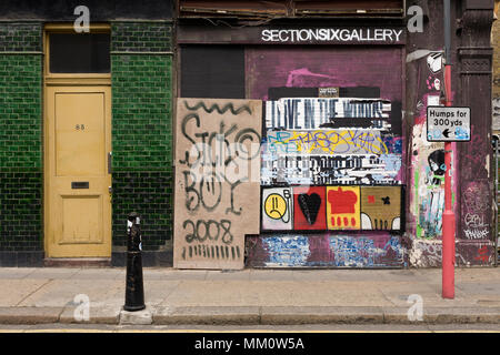 Boarded up shop, covered in graffiti and street art, Redchurch Street, London, E2 Stock Photo