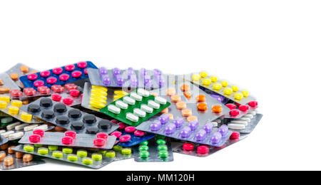Pile of beautiful and colorful pills in blister pack isolated on white background. Health and medicine concept. Pharmaceutical packaging industry conc Stock Photo