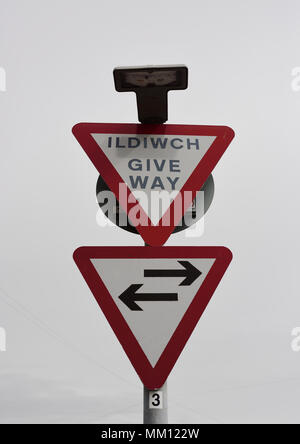 Two Bilingual welsh and english triangular warning signs, give way in north wales uk Stock Photo