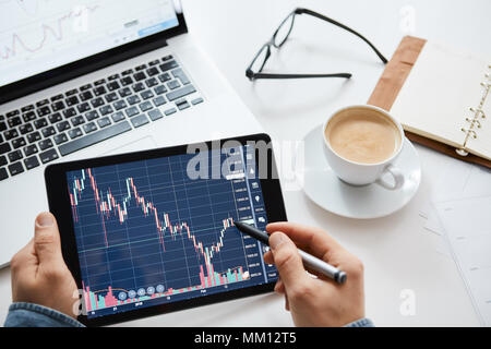 Investor watching the change of stock market on tablet Stock Photo