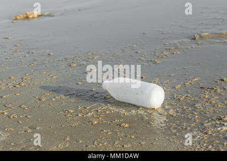 Discarded water bottle laying on a beach. Stock Photo