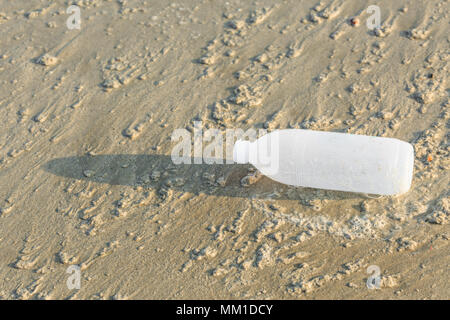 Discarded water bottle laying on a beach. Stock Photo