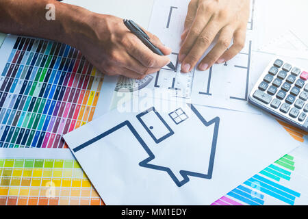 Business, architecture, building, construction concept - close up of architect working on blueprint . Stock Photo