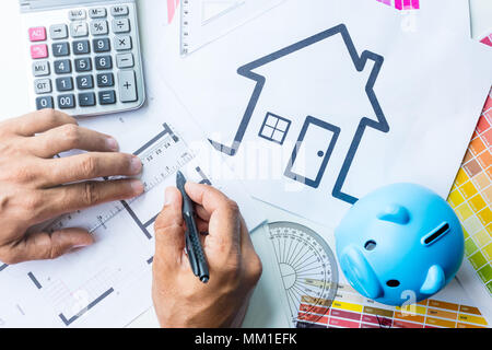 Business, architecture, building, construction concept - close up of architect working on blueprint . Stock Photo