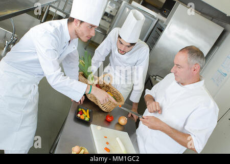 happy chefs working in a kitchen Stock Photo