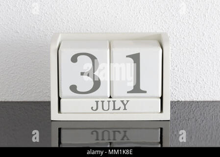 White block calendar present date 31 and month July on white wall background Stock Photo
