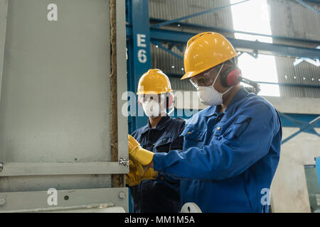 Two blue-collar workers wearing protective equipment  Stock Photo