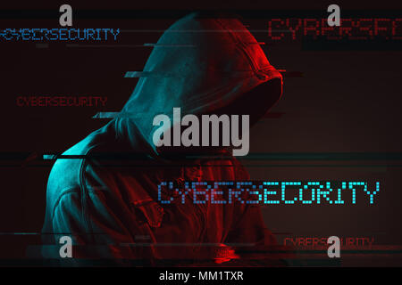 Cybersecurity concept with faceless hooded male person, low key red and blue lit image and digital glitch effect Stock Photo