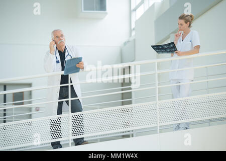 male and female physicians talking on the balcony Stock Photo
