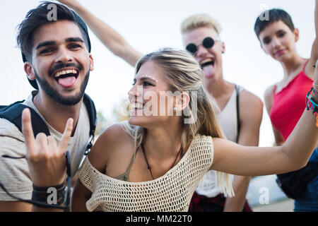 Happy friends having fun at music festival Stock Photo