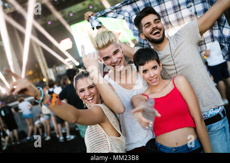 Happy friends having fun at music festival Stock Photo