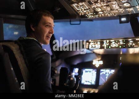 Man pilot plane flight simulator pilots training Stock Photo