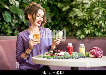 Woman with pills and healthy food Stock Photo